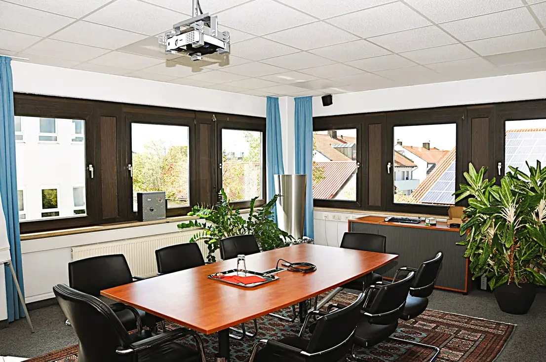 Meeting room on the first floor with conference table and projector
