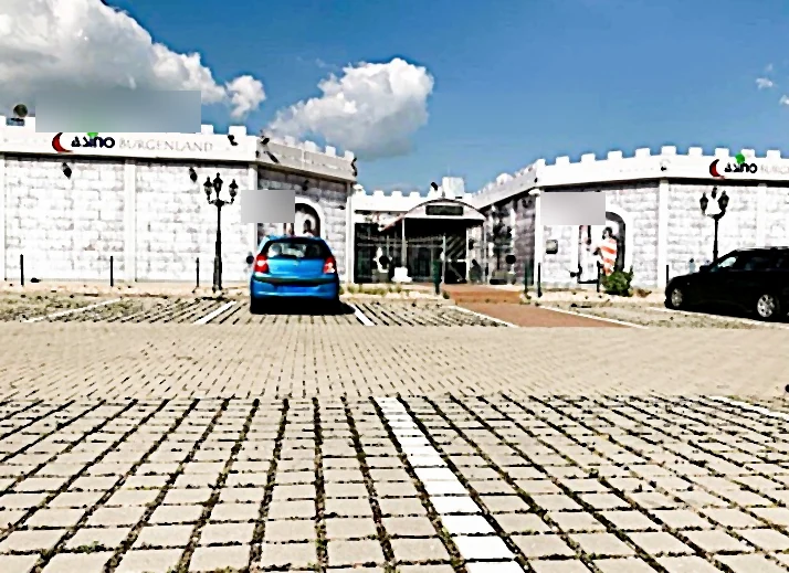 Anonymised street view with parking spaces