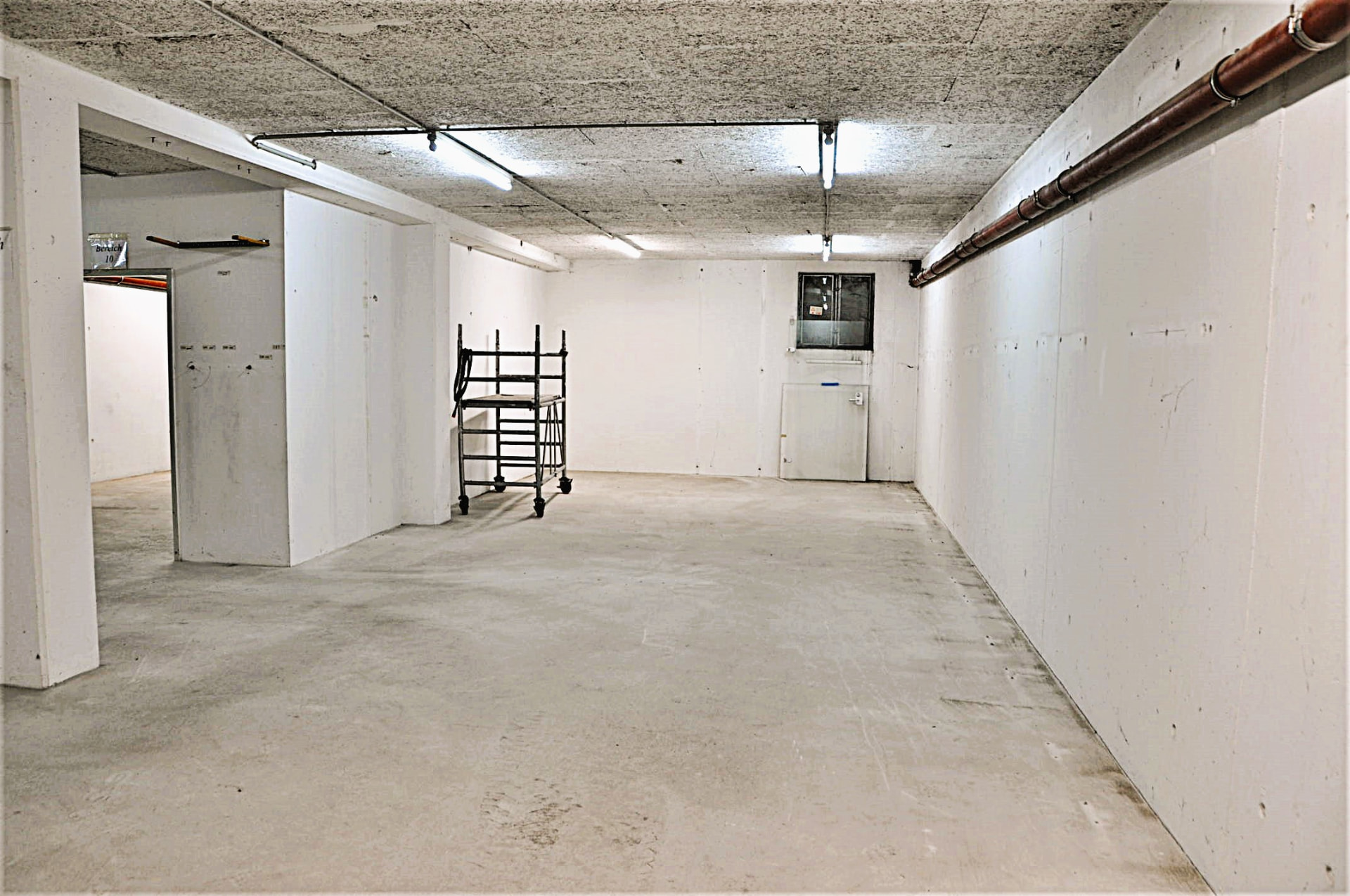 Spacious storage area with durable flooring and lighting