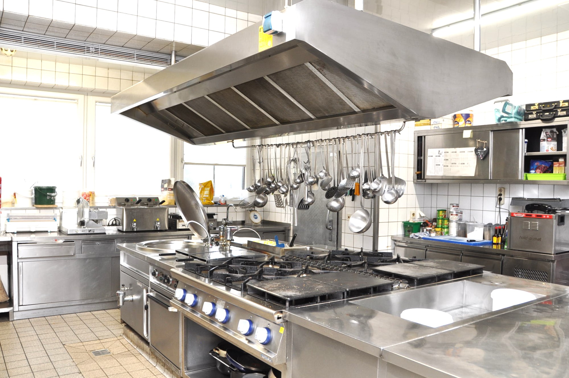 Fully equipped commercial kitchen with gas and electric stoves