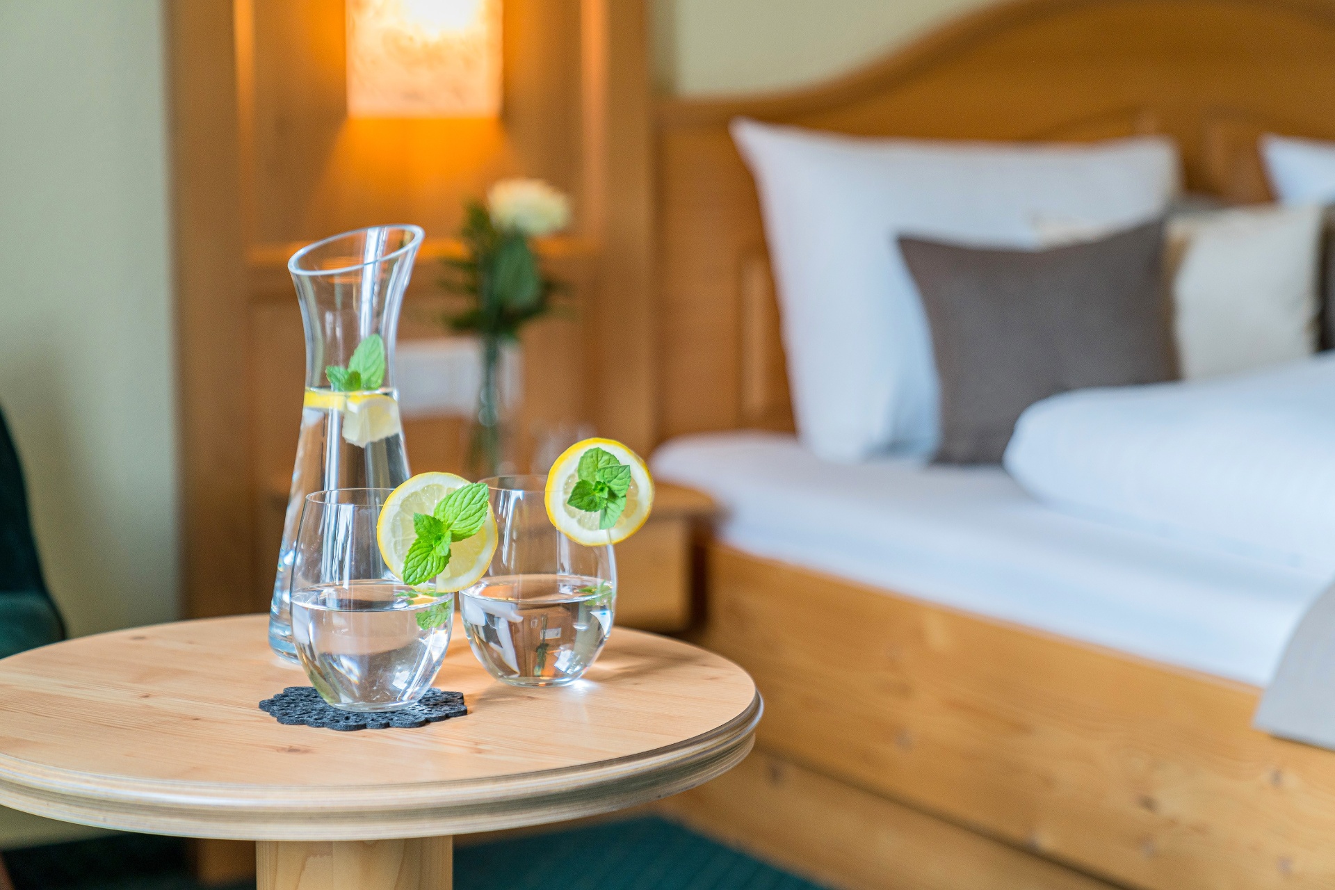 Hotel room impression — Swiss pine bed with fine table decoration