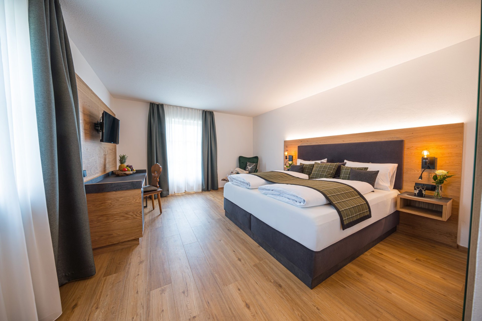 Modernly renovated hotel room with oak bed and box spring